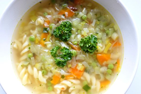 Bowl of vegetable soup with basil oil